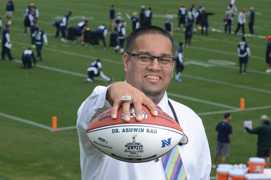 Ashwin Rao ’99 holding a football while wearing his Super Bowl ring.